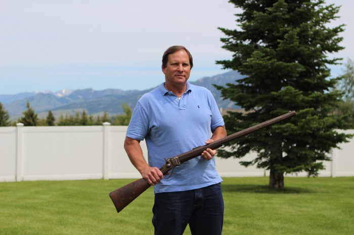 Bill Goodman, an antique firearms dealer, holds a .45-caliber buffalo gun in his backyard in Bozeman, Mont. Jessica Boehm