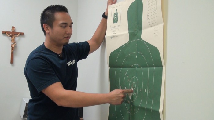 Music Minister Mathew Maglasang shows the target he used in his concealed carry test.  Sydney Stavinoha